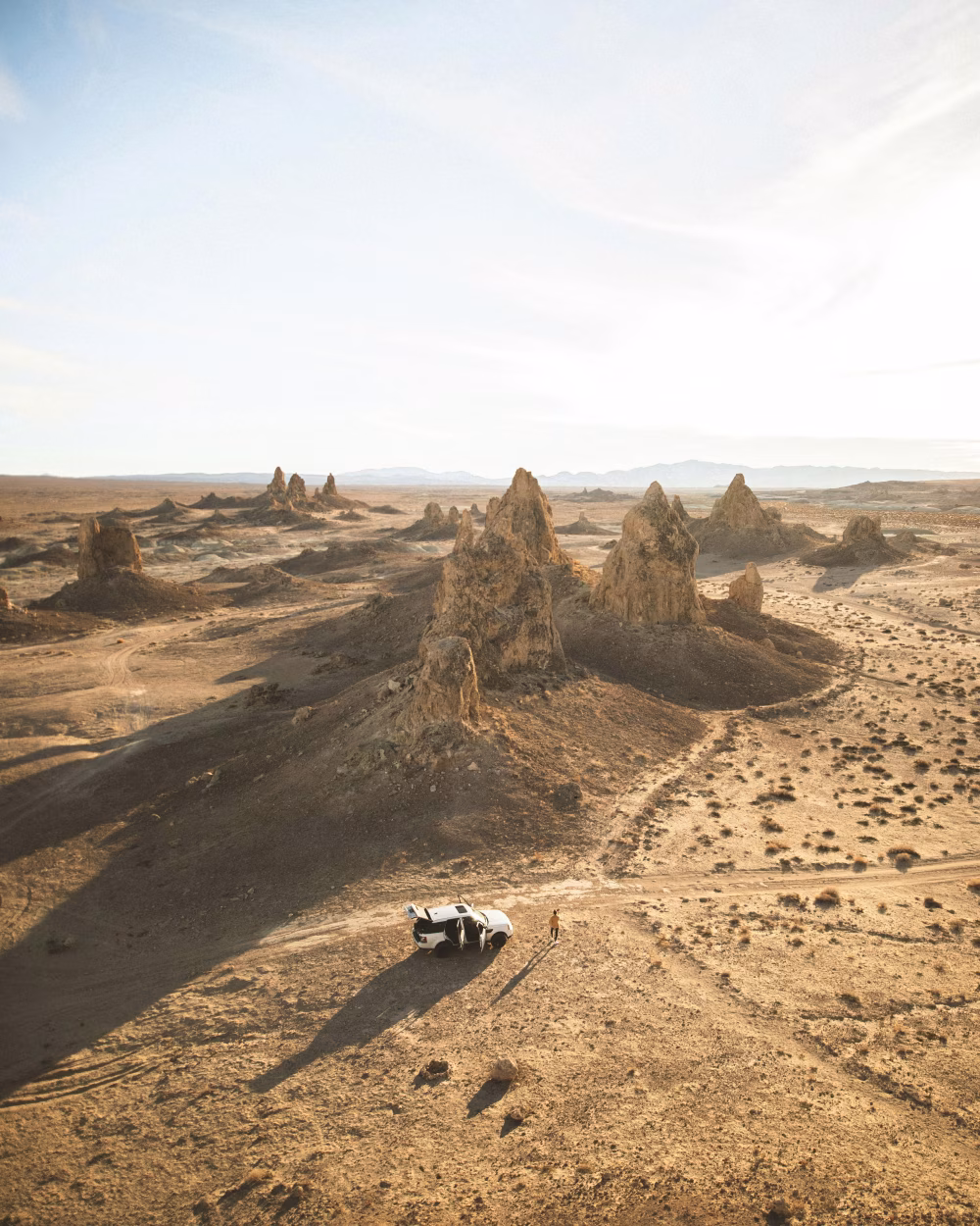A Lone Vehicle in a Scenic Desert Landscape with Rock Formations