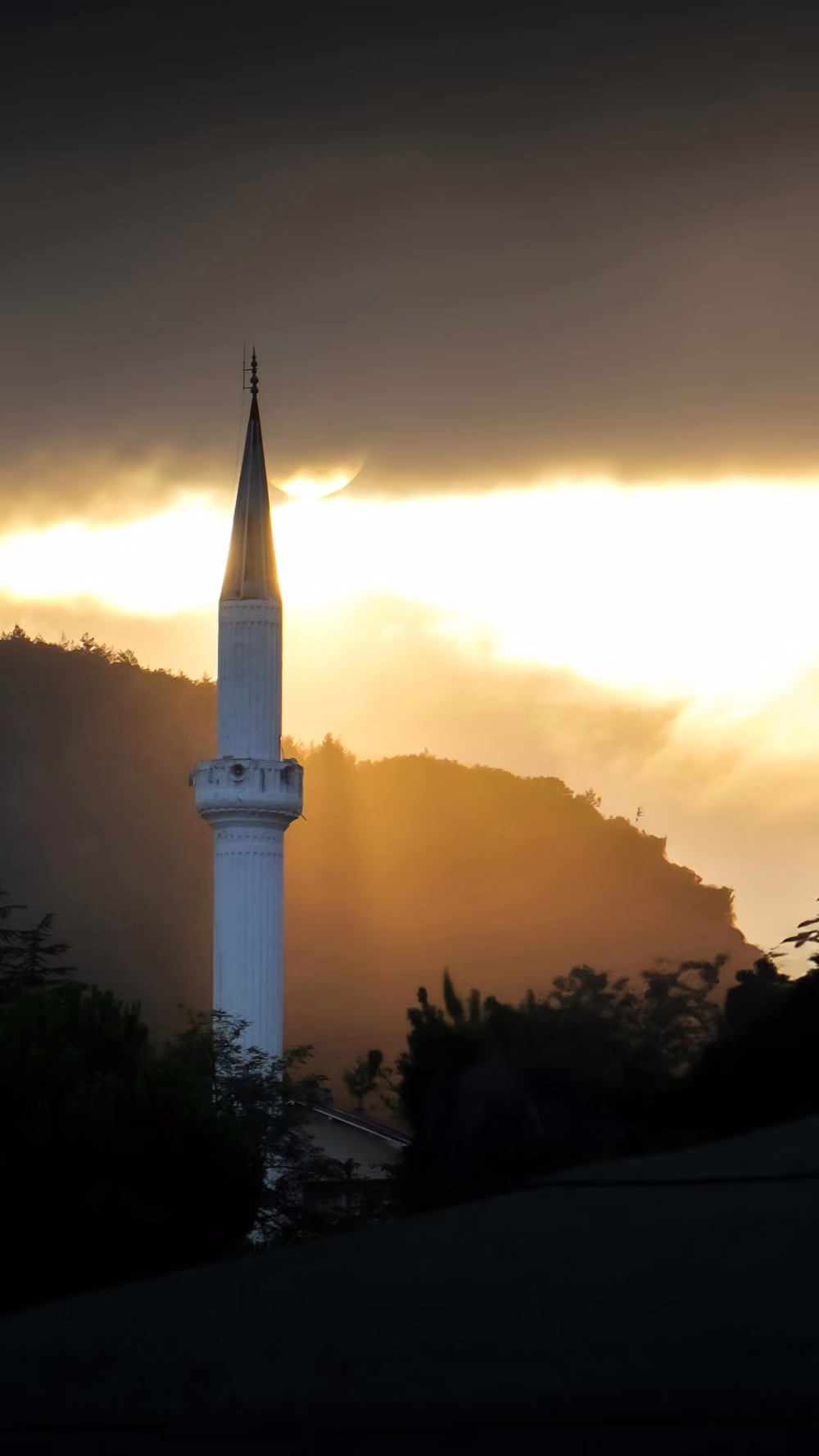 Beautiful Minaret Silhouette at Sunrise with Natural Landscape Background