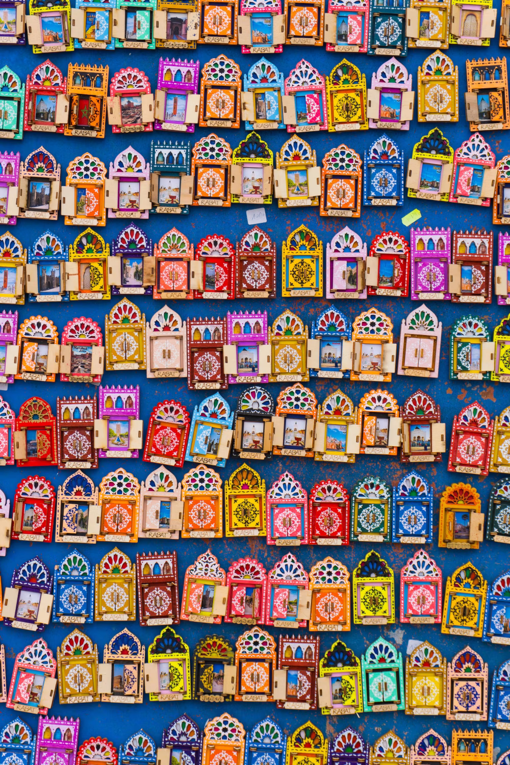 Colorful Handcrafted Decorative Frames Displayed Against a Vibrant Blue Background