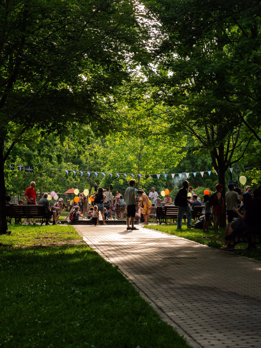 Community Gathering in a Lush Park with Trees and Colorful Decorations