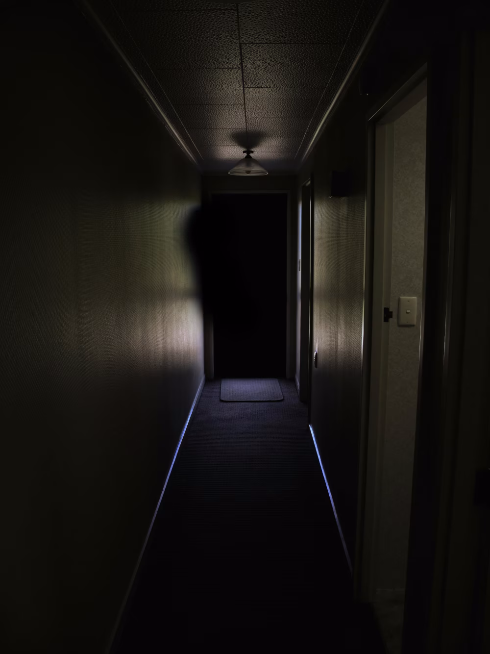 Dark Hallway with Mysterious Shadows and Eerie Lighting