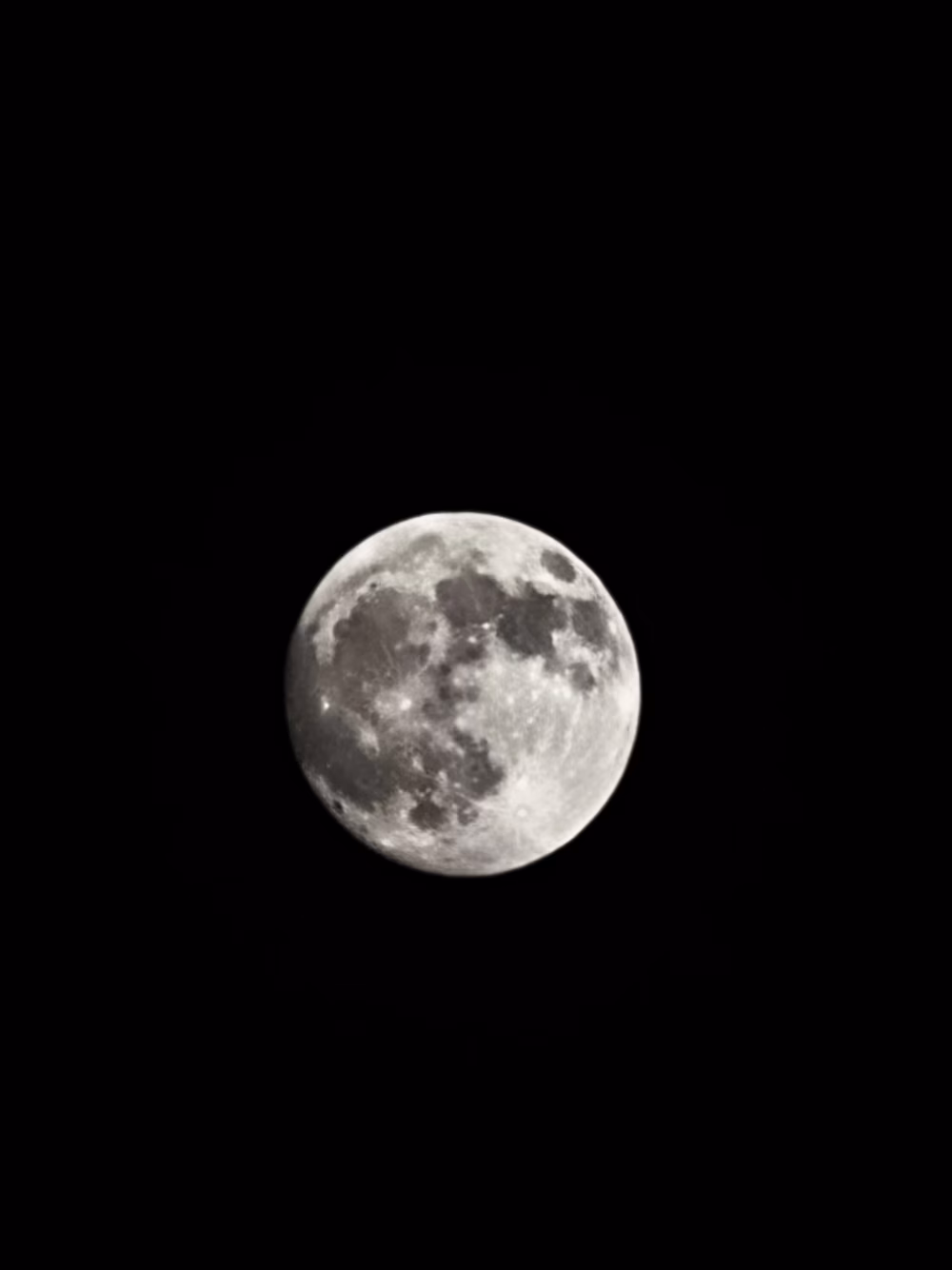 Full Moon Over Black Night Sky: Sharp Lunar Image With Craters and Silvery Glow
