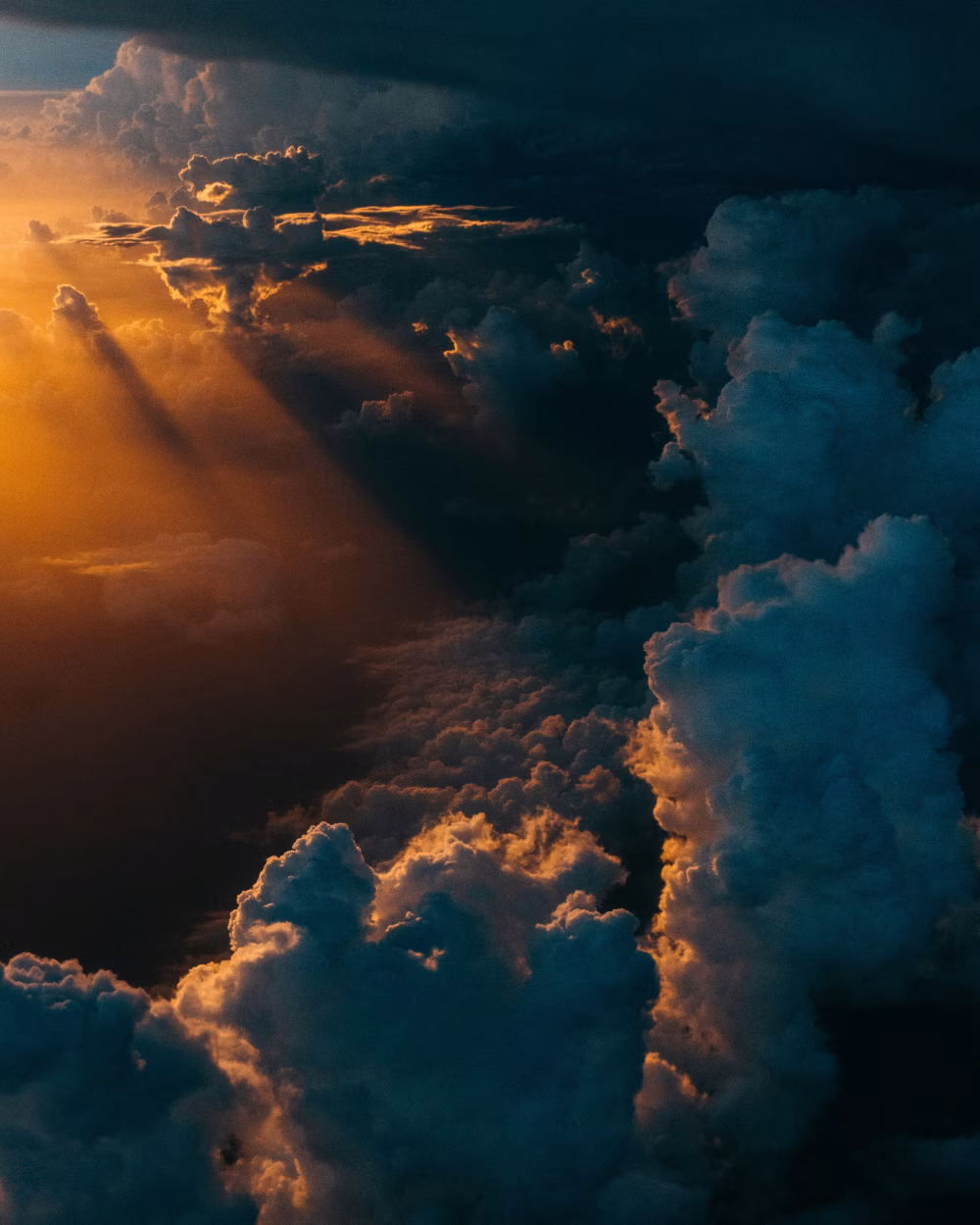 Golden Light Streaming Through Dramatic Clouds at Sunset