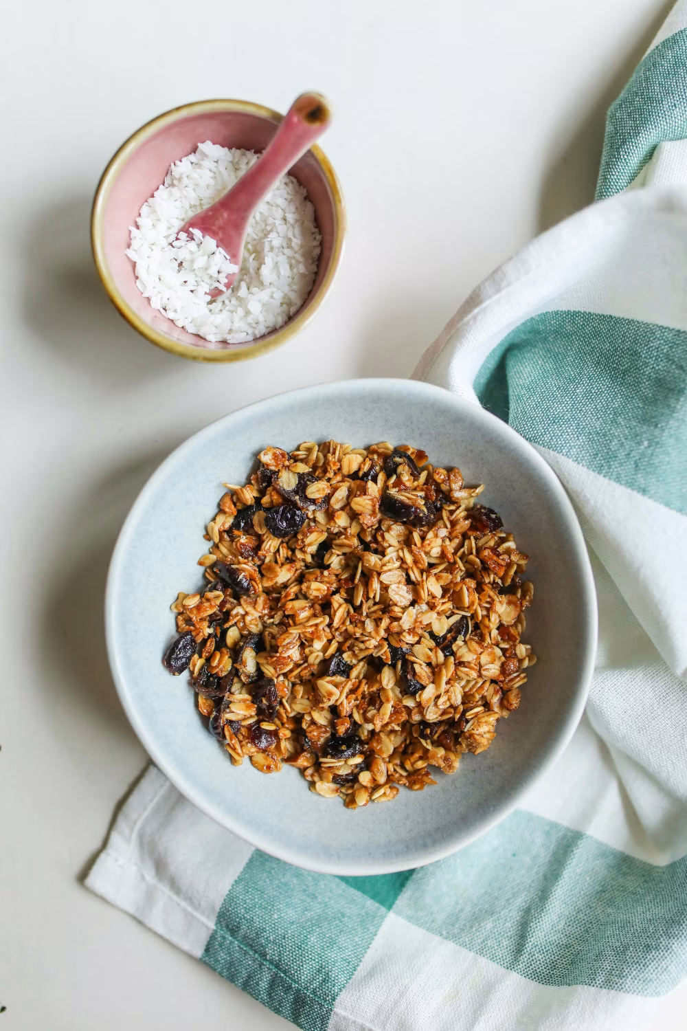 Healthy Homemade Granola Breakfast with Coconut Topping on a Light Table Surface