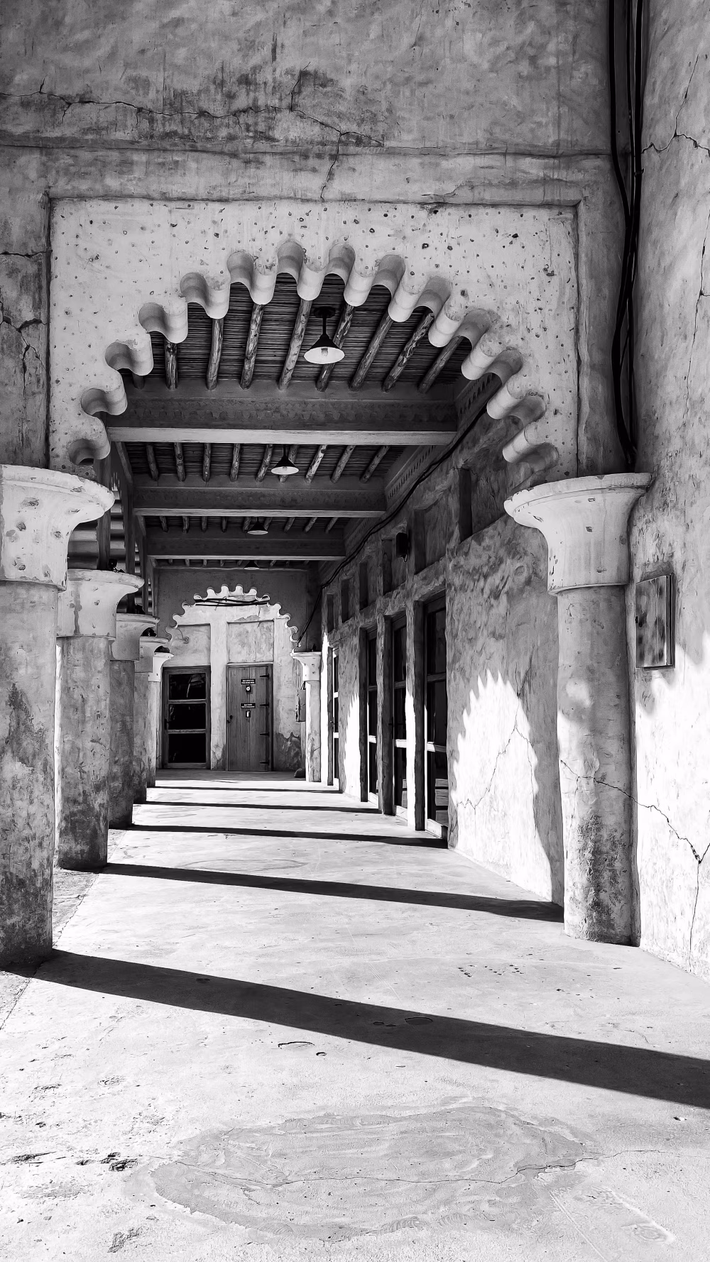 Historic Corridor with Decorative Archways in Black and White