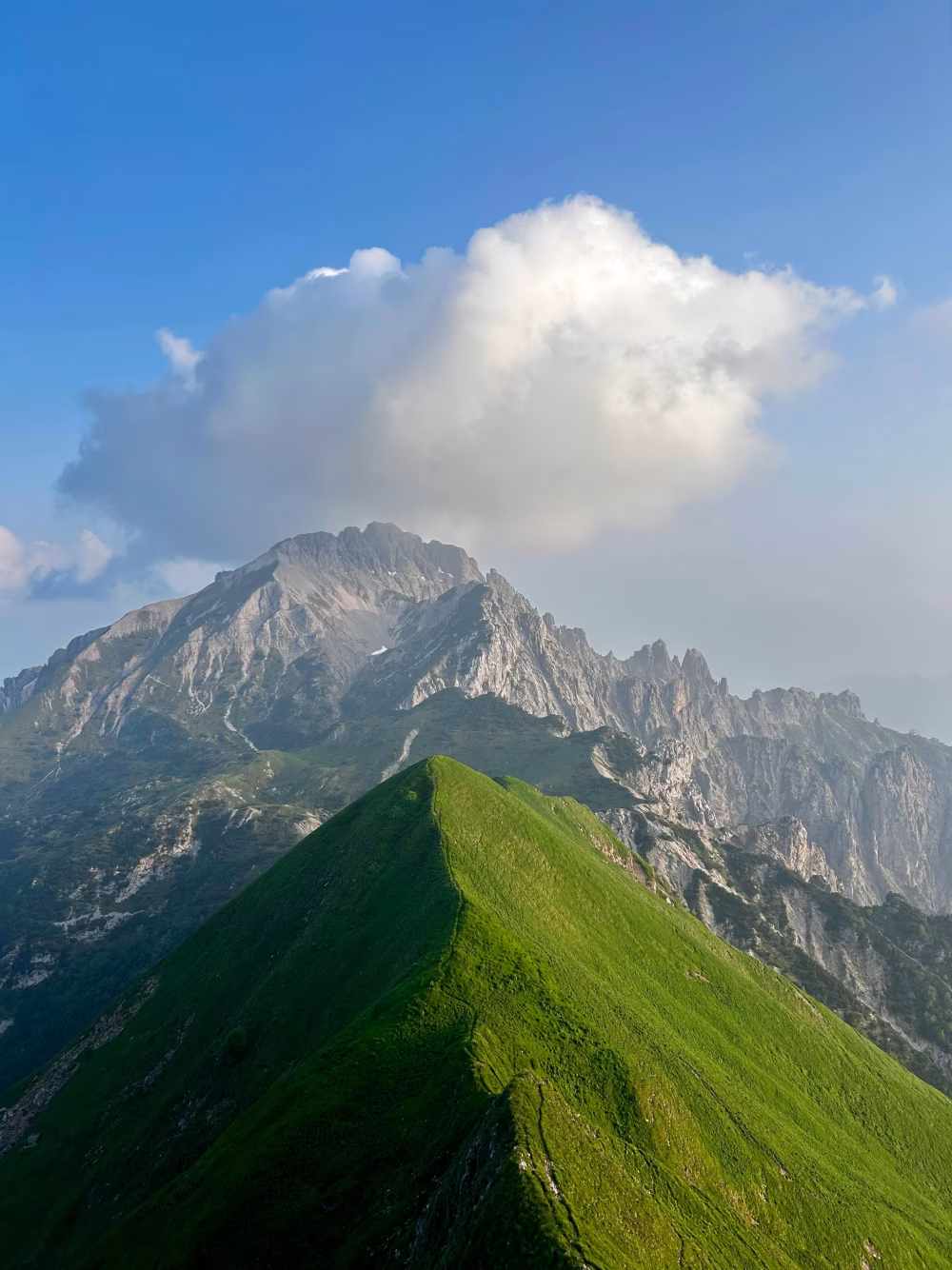 Majestic Mountain Peak With Lush Green Ridge and Dramatic Clouds