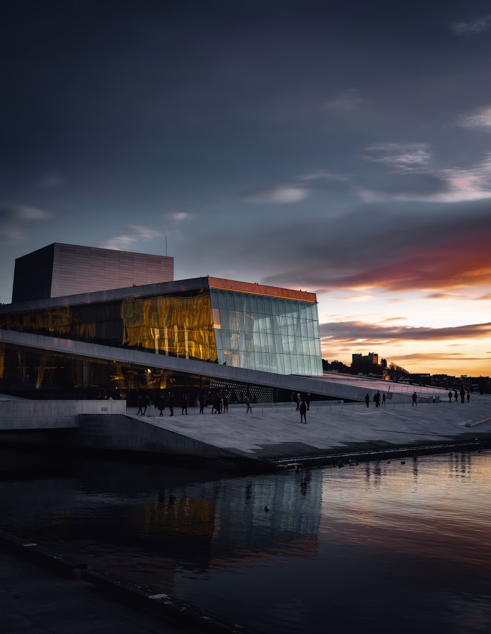 Modern Architecture by Waterfront During Sunset with Reflections and Warm Lighting