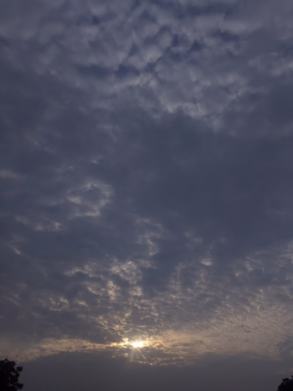 Peaceful Sunrise Over a Cloudy Horizon With Soft Blue Shades