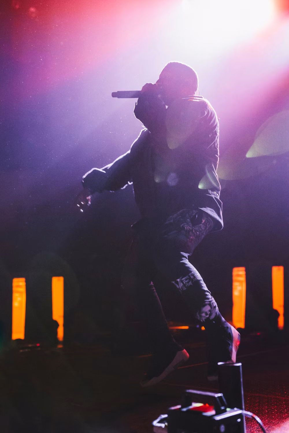 Silhouette of Singer on Stage with Dramatic Spotlighting