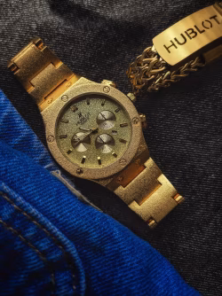 Elegant Golden watch on denim background