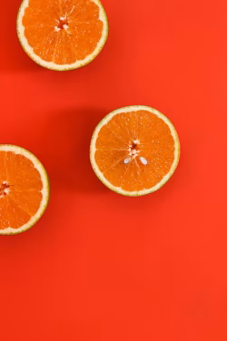 Fresh Orange Slices on Bold Red Background