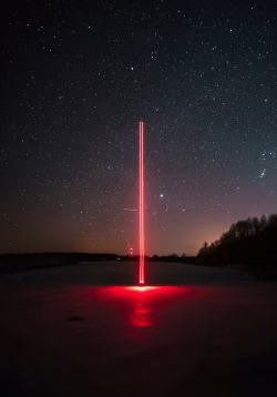Glowing Red Light Beam Under Starry Night Sky in a Remote Landscape