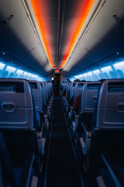Interior View of Airplane Cabin with Empty Seats and Modern Lighting