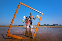 Joyful Children Running Through Water in a Vibrant Outdoor Setting