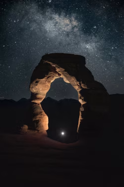 Nighttime Arch With Illuminated Starry Milky Way Sky in Desert Landscape