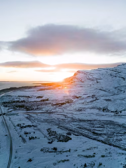 Scenic Sunrise Over Snow-Covered Landscape and Distant Horizon