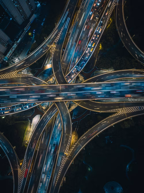 Aerial View of Illuminated Urban Highway Interchange During Night Hours