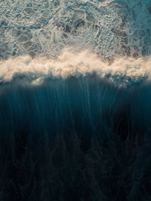Aerial View of Ocean Waves Breaking with Textured Foam Patterns