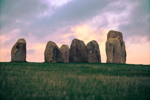 Ancient Stone Circle on Green Field at Sunset