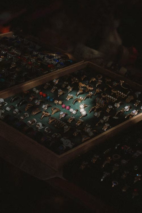 Array of Elegant Rings Displayed in a Jewelry Box Under Dark Lighting