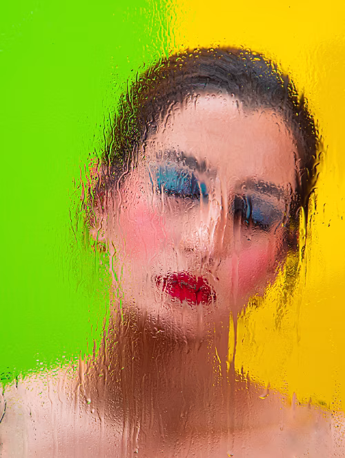 Artistic Portrait Through Wet Glass with Bright Green and Yellow Background