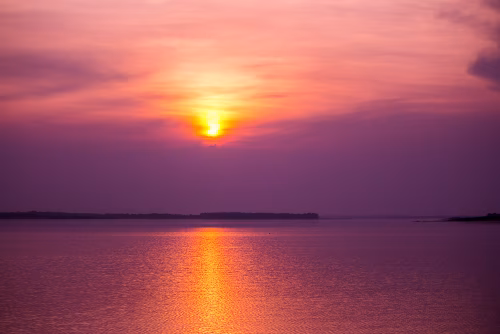 Beautiful Sunset with Vibrant Sky Over Calm Lake Waters