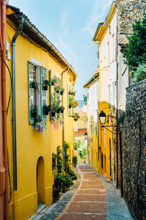 Charming Narrow Alley with Vibrant Yellow Houses and Flowered Windows