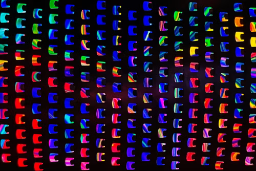 Colorful Abstract Grid with Neon Spectrum Lighting on Dark Background