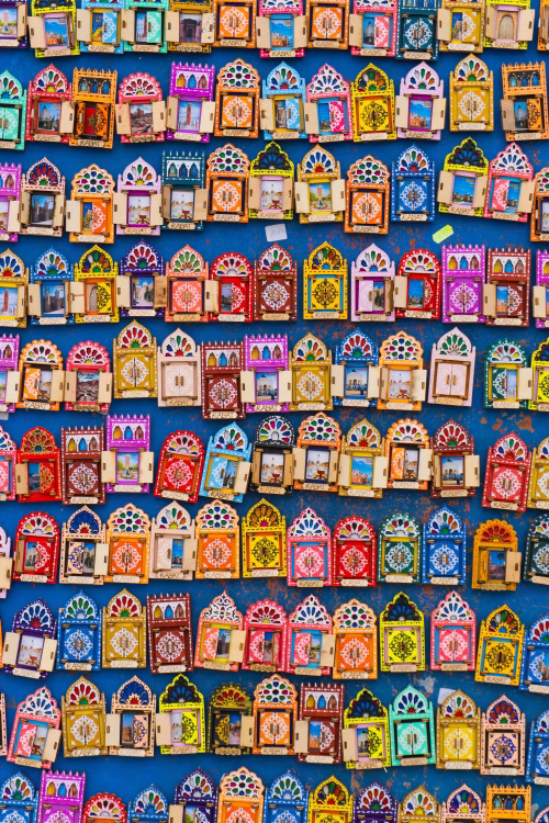 Colorful Handcrafted Decorative Frames Displayed Against a Vibrant Blue Background