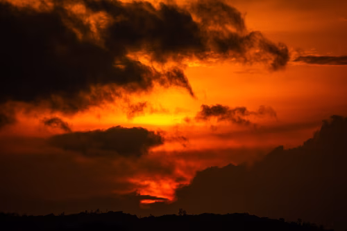 Colorful Sunset with Scenic Clouds Over a Peaceful Landscape