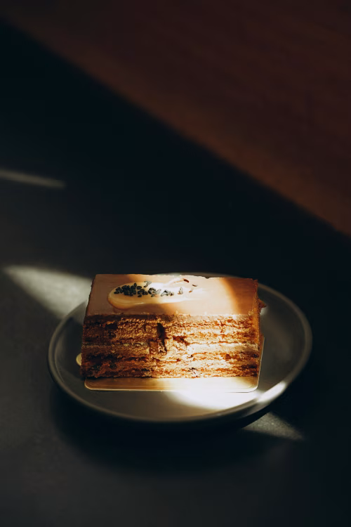 Delicious Layered Cake on a Plate Highlighted by Sunlight