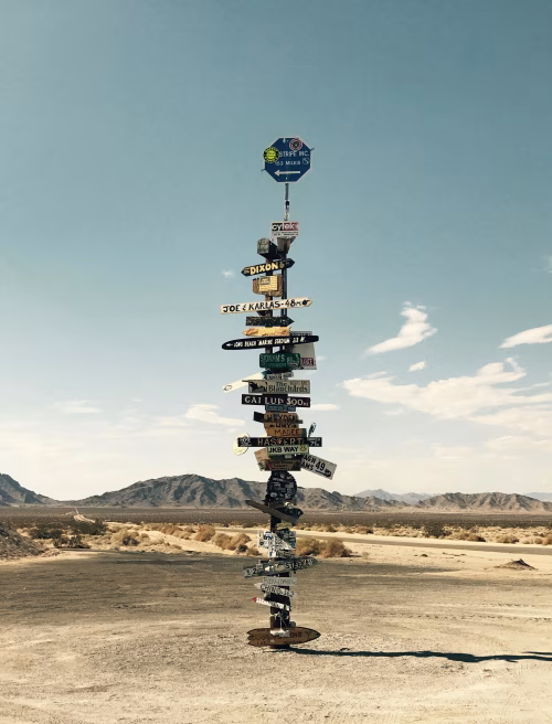 Directional Signs in Desert Landscape Under Clear Sky