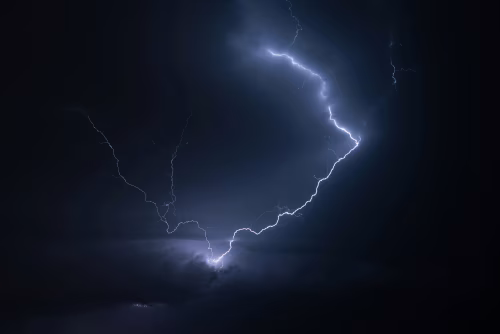 Dramatic Lightning Strike Illuminating a Dark Cloudy Night Sky