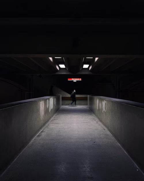 Dramatic Urban Tunnel With Silhouetted Pedestrian Under Artificial Light
