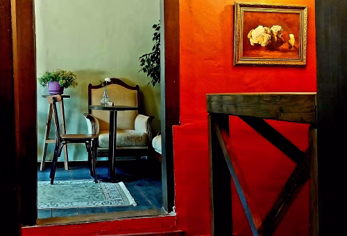 Elegant Vintage Interior With Armchair and Framed Floral Art