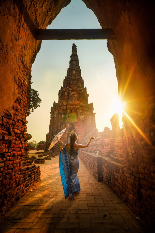Elegantly Dressed Woman at Ancient Temple Under Golden Sunlight