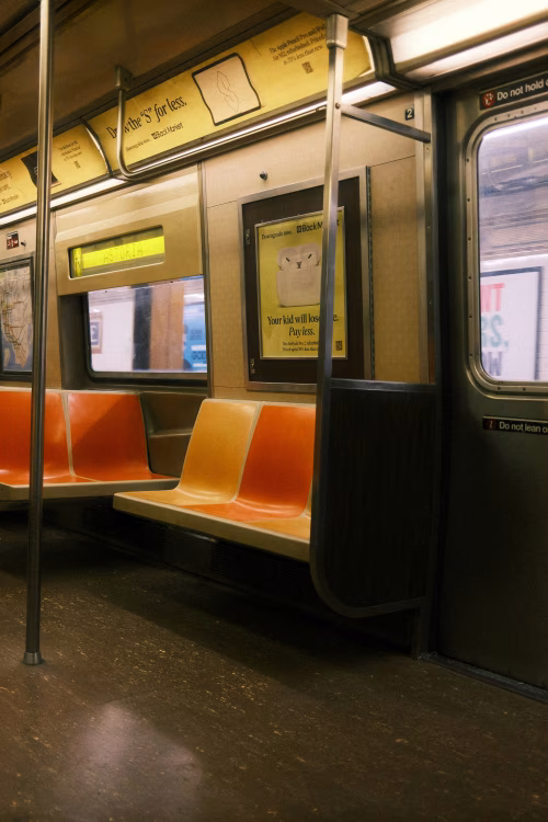 Empty Subway Interior With Bright Orange Seats and Soft Lighting