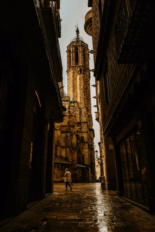Historic Gothic Cathedral in a Narrow Street Under Cloudy Weather
