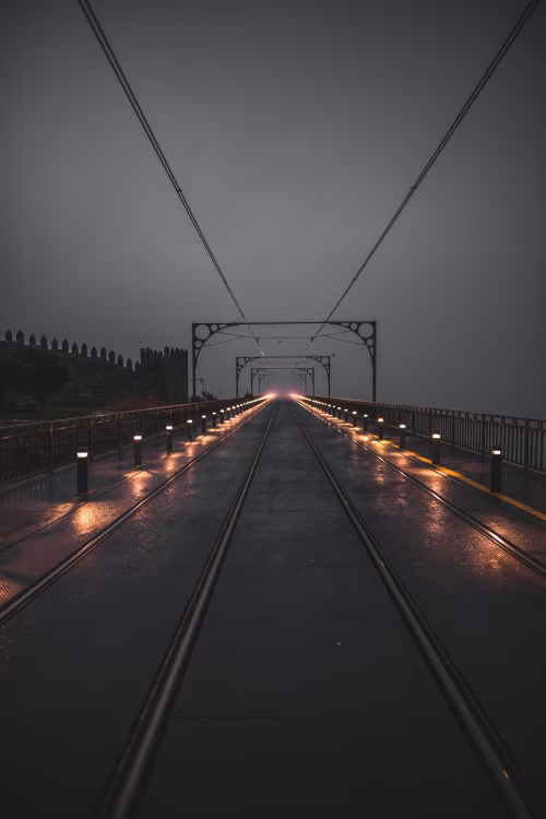 Illuminated Railway Track on Foggy Evening with Perspective Depth