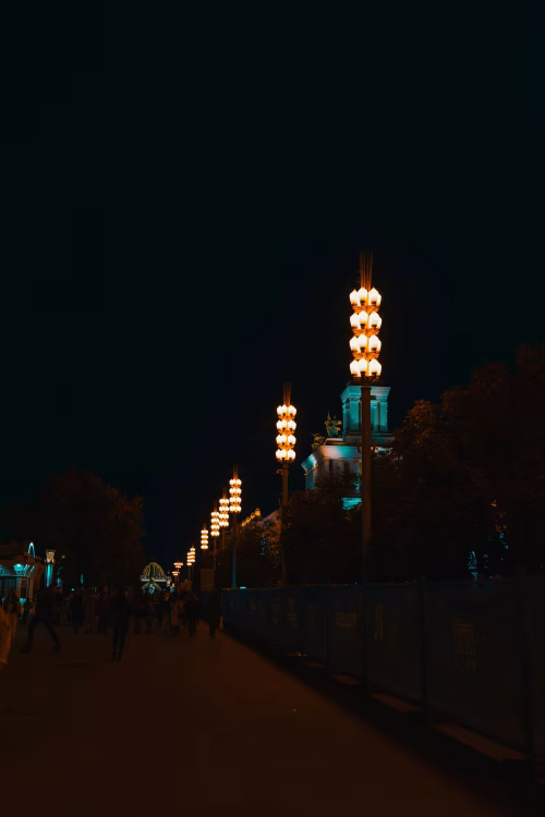 Illuminated Street at Night with Decorative Lamps and Building