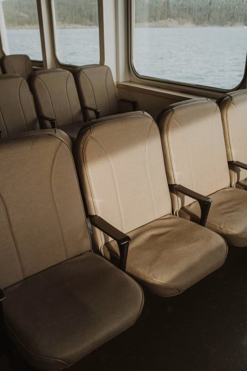 Interior of Boat with Rows of Empty Seats and Scenic Water View