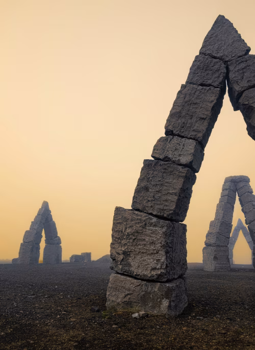 Majestic Stone Arch Structures Against a Serene Sunset Sky