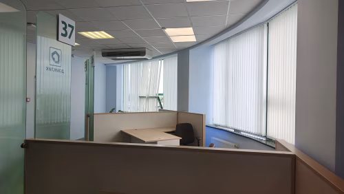 Modern Office Space with Partitioned Workstations and Bright Ambient Lighting