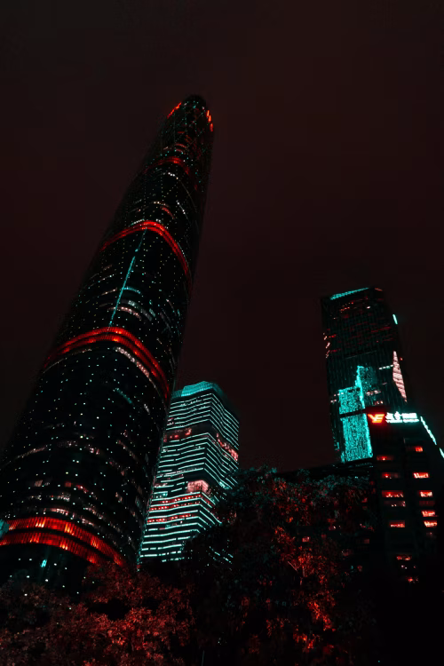 Modern Skyscrapers Illuminated by Neon Lights in Evening Sky