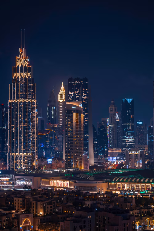 Modern Urban Skyline with Illuminated Skyscrapers at Night