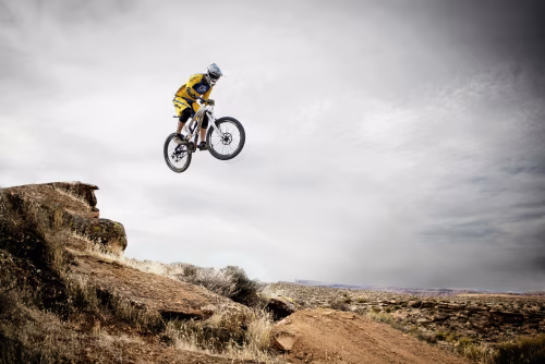 Mountain Biker Performing Thrilling Jump in Rugged Desert Landscape