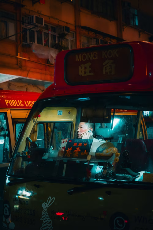 Night View of a Minibus in a Bustling Urban City