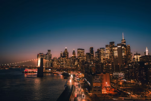Nighttime Cityscape with Illuminated Bridge and Towering Skyscrapers