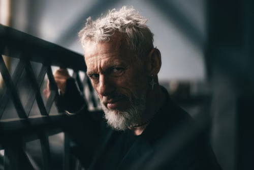 Portrait of an Elderly Man with Striking Expression in a Dark Setting