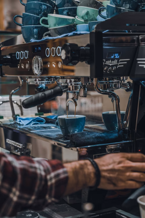 Professional Barista Preparing Coffee with a Modern Espresso Machine